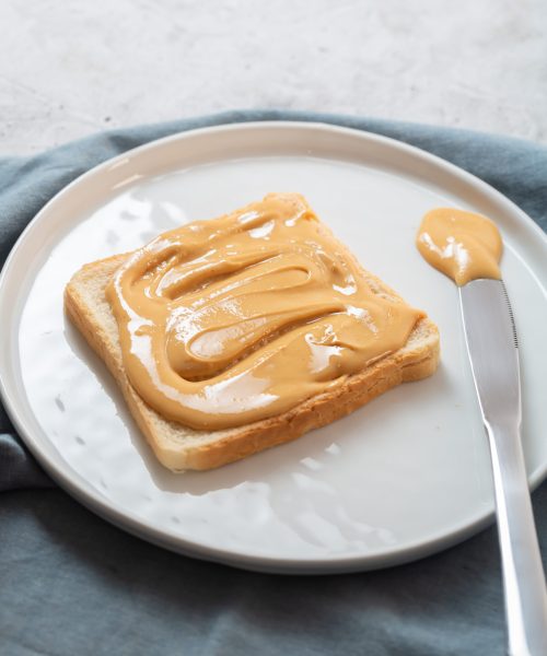 Nut butter with bread on the table prepared for breakfast. It is rich in several nutrients, including protein and magnesium, which may help protect the heart and manage blood sugar and body weight