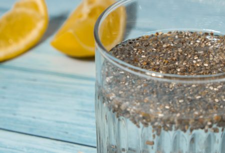 Preparing superfood water drink rich in Omega 3 fatty acids. Pouring coconut water. Adding soaked chia seeds and lemon detox Breakfast. Clean eating, weight loss, dieting food concept Vegetarian Healthy cooking process